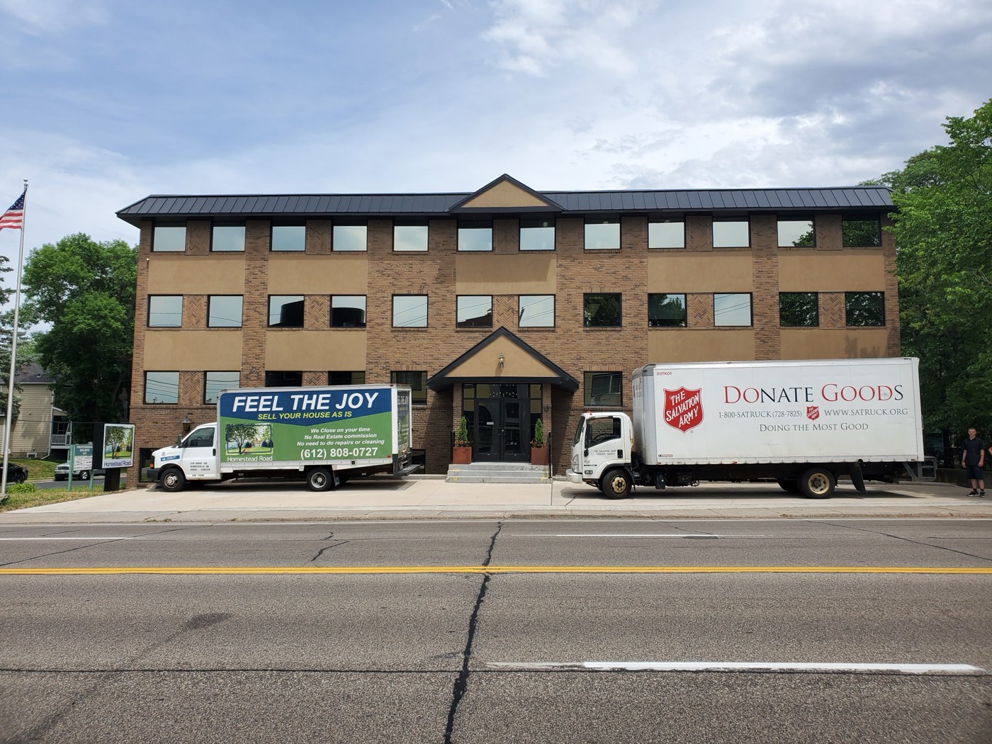 The Salvation Army donation truck parked beside a Homestead Road van outside the Homestead Road office during a goods donation drive